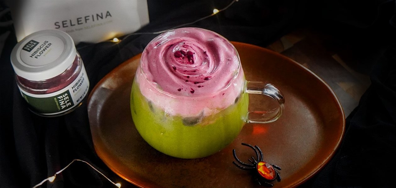 Zombie Matcha Latte: bright green iced matcha under a swirl of magenta hibiscus foam