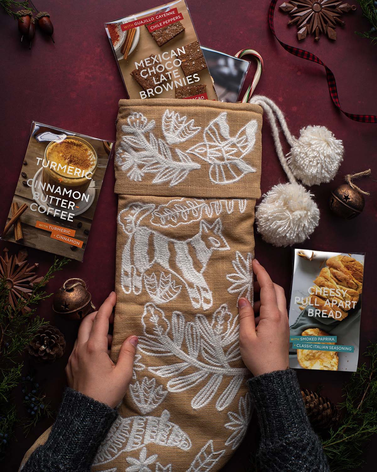Recipe Sampler cards tucked into a knit stocking among greenery and ornaments