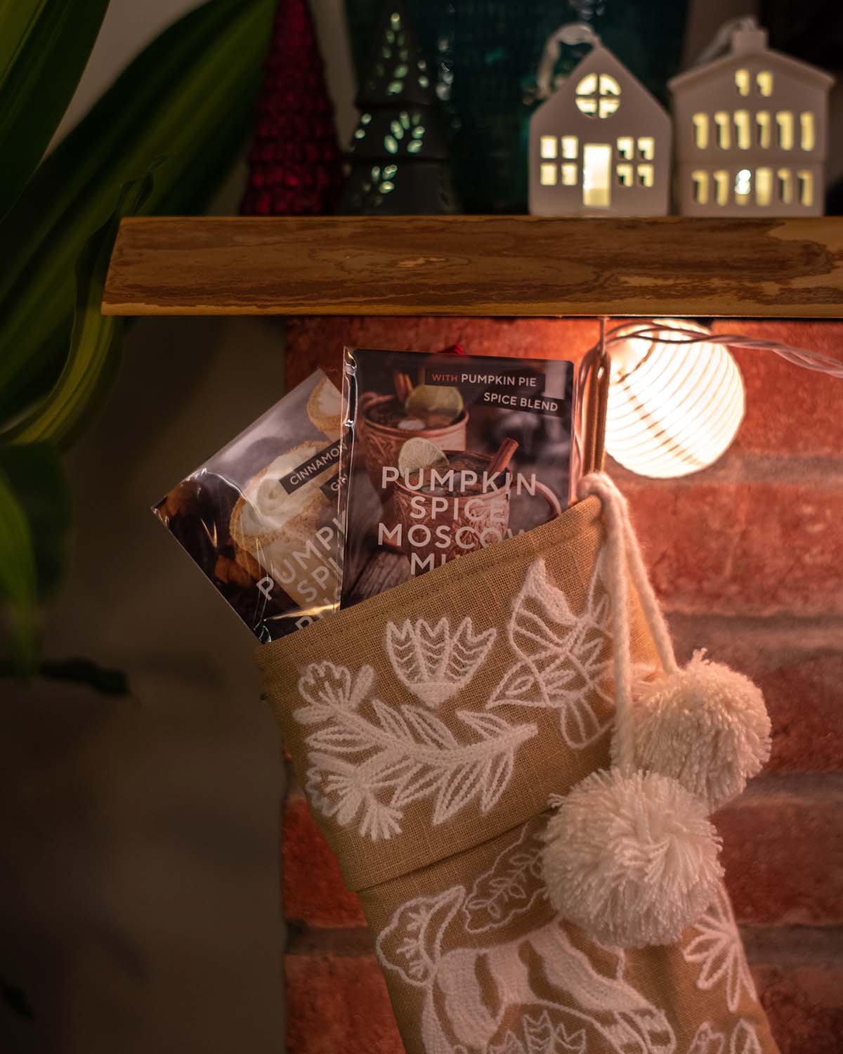 A wrapped Recipe Sampler tied with ribbon on a holiday table